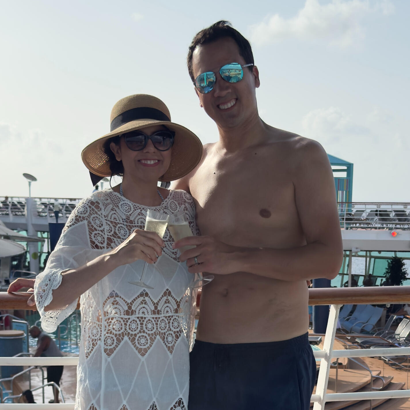 David and Carolyn pose for a cruise photo in front of a staircase.